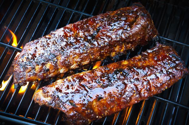 rack of baby back pork ribs on bbq grill