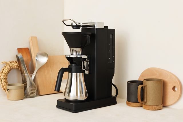 a coffee maker with a couple of coffee cups